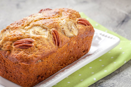 Sliced banana bread with a pecan