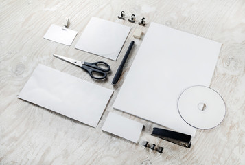 Blank corporate identity set on light wooden table background. Blank objects for placing your design. Mockup for branding identity. ID template. Top view.