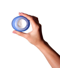 Jar of cream in female hands, close up