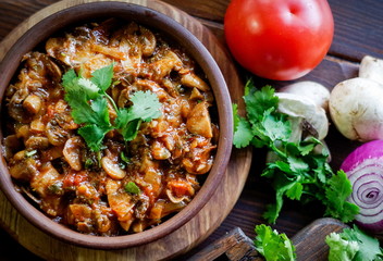 Georgian Satsivi with mushrooms onions and tomatoes in a clay plate