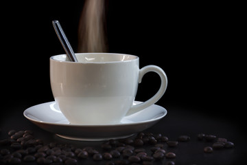 Hot cup of coffee in white on a dark background.