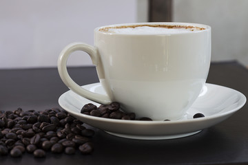 Hot coffee in a white cup on the table.