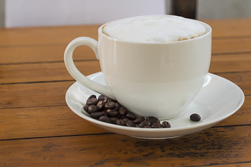 Hot coffee in a white cup on the table.