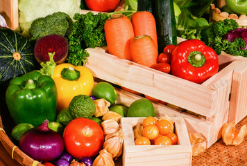 Arrangement fresh fruits and vegetables in wooden container