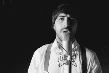 Singer with microphone and black background