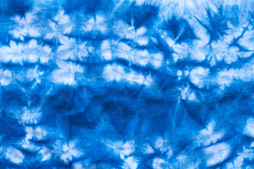 Pattern of blue tie batik dye on cotton cloth, Dyed indigo fabric background and textured, Painted blue watercolor on white cotton cloth