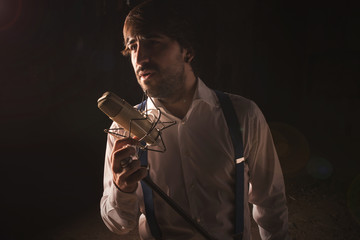 Singer with microphone and black background