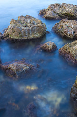 Sea and stones on a long exposure during sunset.