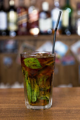 alcohol cocktail on wooden bar with bar background