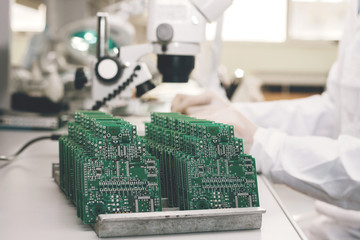 Technician with computer circuit board with chips. Spare parts and components for computer...