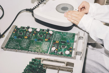 Technician with computer circuit board with chips. Spare parts and components for computer...
