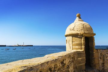 Fototapeta na wymiar Turret of medieval Castle of Santa Catalina at the seafront of Cadiz Spain. 