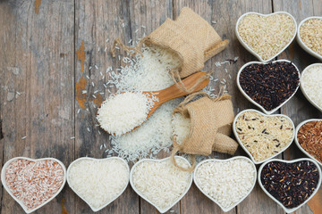 Top view jasmine rice and different rice on old plank