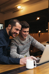 Friends using mobile and laptop.