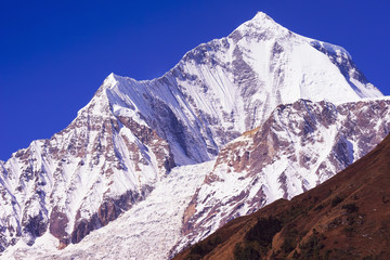 Fototapeta premium Daulagiri summit view with glacier and blue sky background. Nepal landscape, Annapurna circuit, Himalaya mountains, Asia