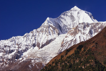 Fototapeta na wymiar Daulagiri summit view with glacier and blue sky background. Nepal landscape, Annapurna circuit, Himalaya mountains, Asia