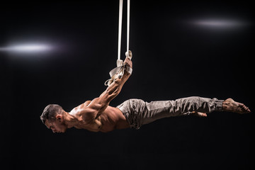 circus artist on the aerial straps man
