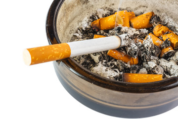 Close up of cigarette in ashtray on white background