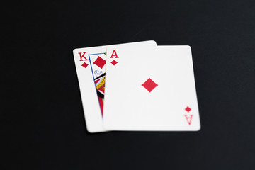 Playing poker cards ace king on black background