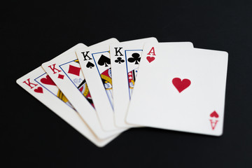 Four of a kind in poker cards game on a black background