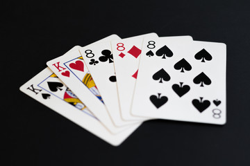 Full house in poker cards game on a black background