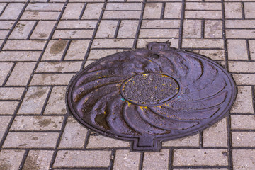 sewer and drainage manholes on the roads and sidewalks