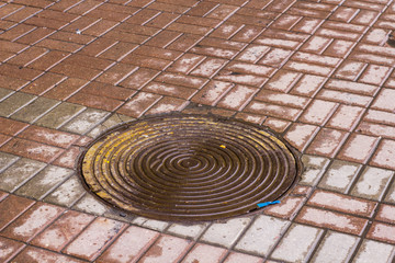 sewer and drainage manholes on the roads and sidewalks