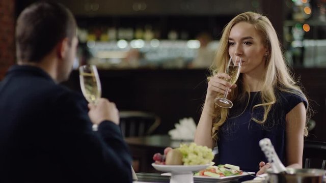 lovers drinking champagne in restaurant