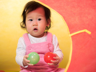 Fototapeta na wymiar cute smiling baby girl play toy at home