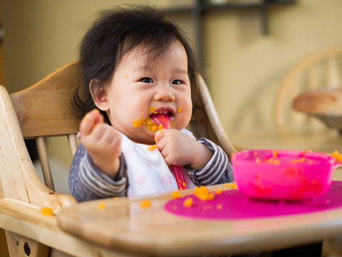 Baby Girl Eating Mashed Sweet Potatoes