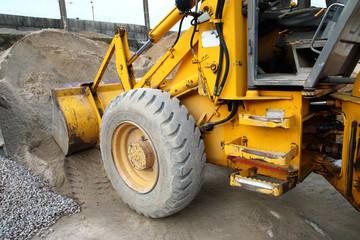 yellow excavator in the sand