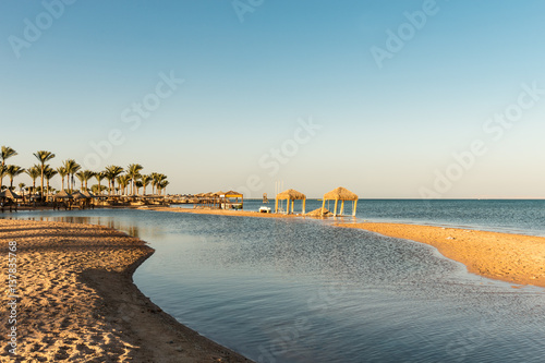 Palm trees over a Red Sea beach at sunset