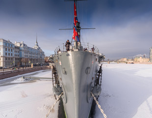 Russia, Saint-Petersburg, 10 February 2017: Aero shootings of a winter panorama monument of October revolution cruiser the Aurora at sunset, the Nakhimov Military Naval School, frozen river Neva