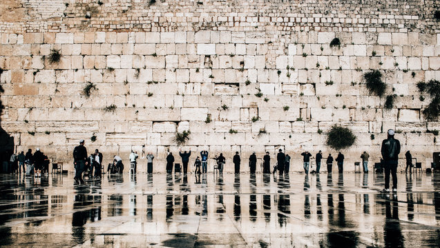 Jewish people praying at the western wall in the old town of Jerusalem, Israel.