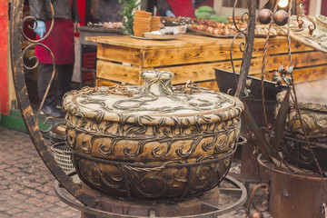 large colorful ceramic pots with food on the grill