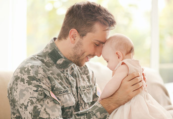 Military father holding his newborn baby