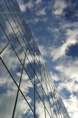 Fototapeta na wymiar Glass Building for Business Reflection of Blue Sky and Clouds