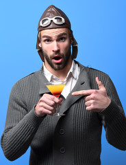 bearded pilot with cocktail in glass