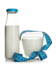 Diet concept. Milk and measuring tape isolated on white