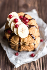 Peanut cookies with banana and berries on a wooden background