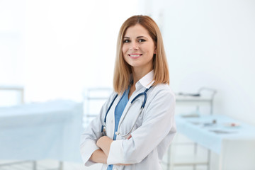 Beautiful doctor with stethoscope in modern clinic