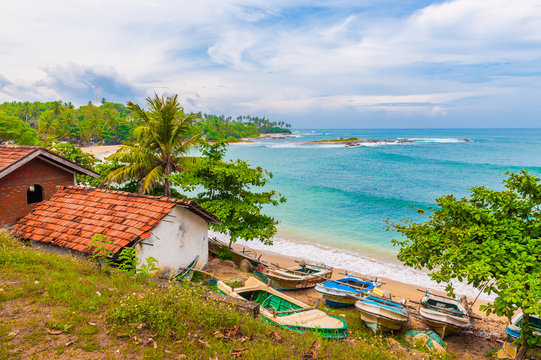 Küstenlandschaft mit  traditionellen Fischerbooten in Sri Lanka, Blick auf den Indischen Ozean