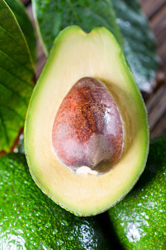 Fresh organic avocado on old wooden table. The composition of pictures in close-up.