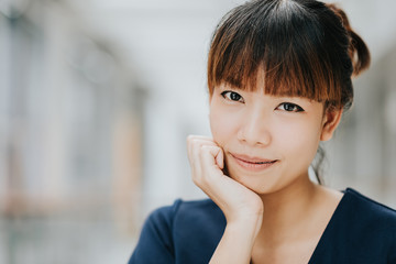 Portrait of young happy Asian girl smiling indoor