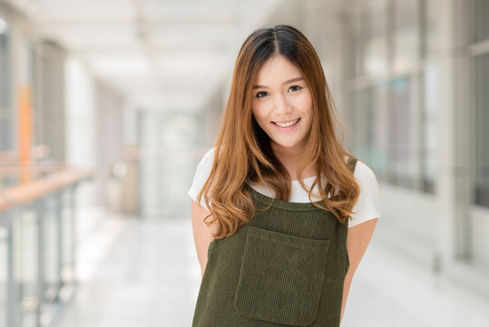 Portrait of young beautiful happy Asian girl smiling indoor