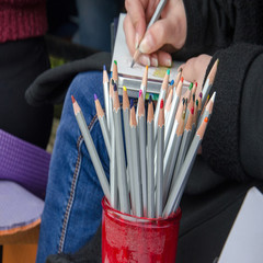 A set of colored pencils in red glass
