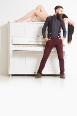 Fototapeta na wymiar bearded man and girl with piano