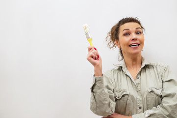 Girl house painter builder at work.