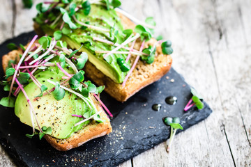 Delicious vegan sandwich with avocado and radish cress - obrazy, fototapety, plakaty