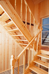 staircase and banisters inside of wooden house